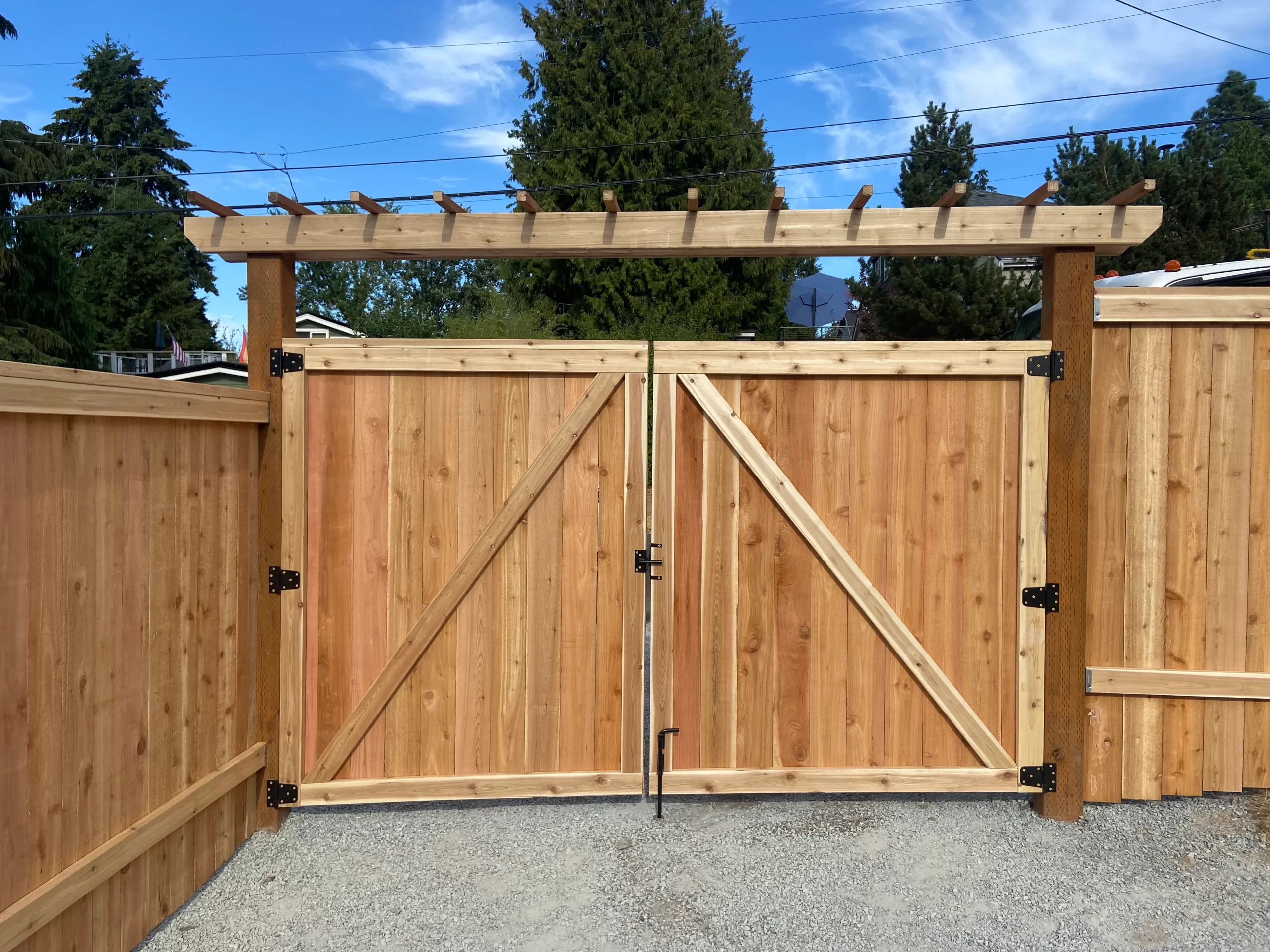 cedar double gate installation with overhead arbor by fence contractor in Mercer Island