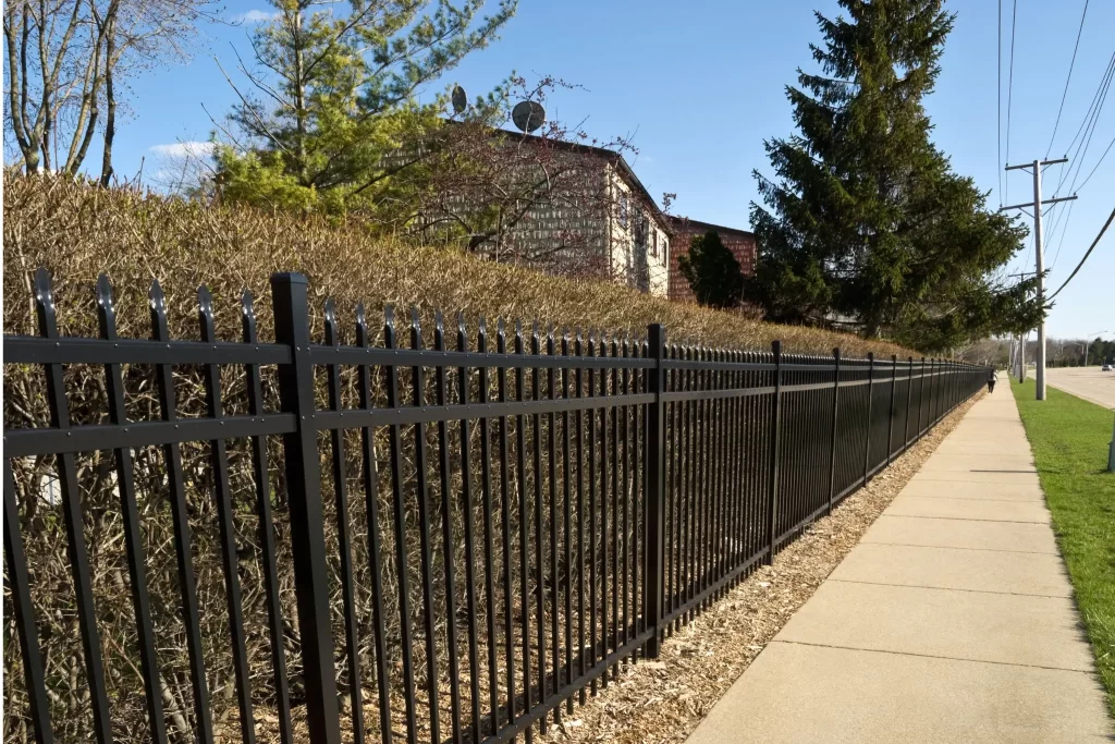 Aluminum fence next to sidewalk