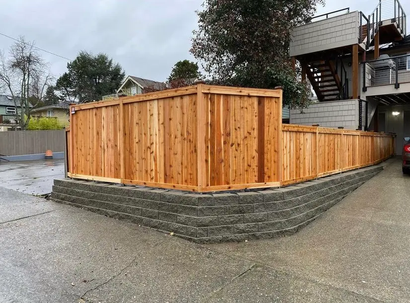 Cedar privacy fence with block retaining wall installed in Seattle by DH Fence Pros