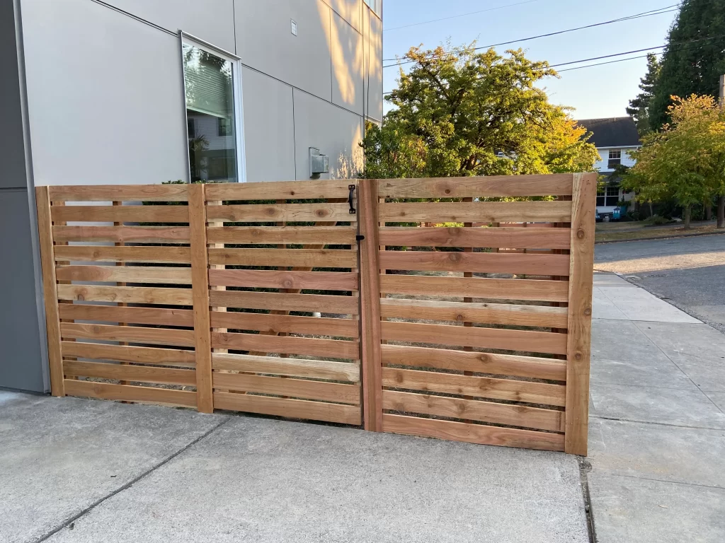 Double horizontal cedar gate with modern slatted design.