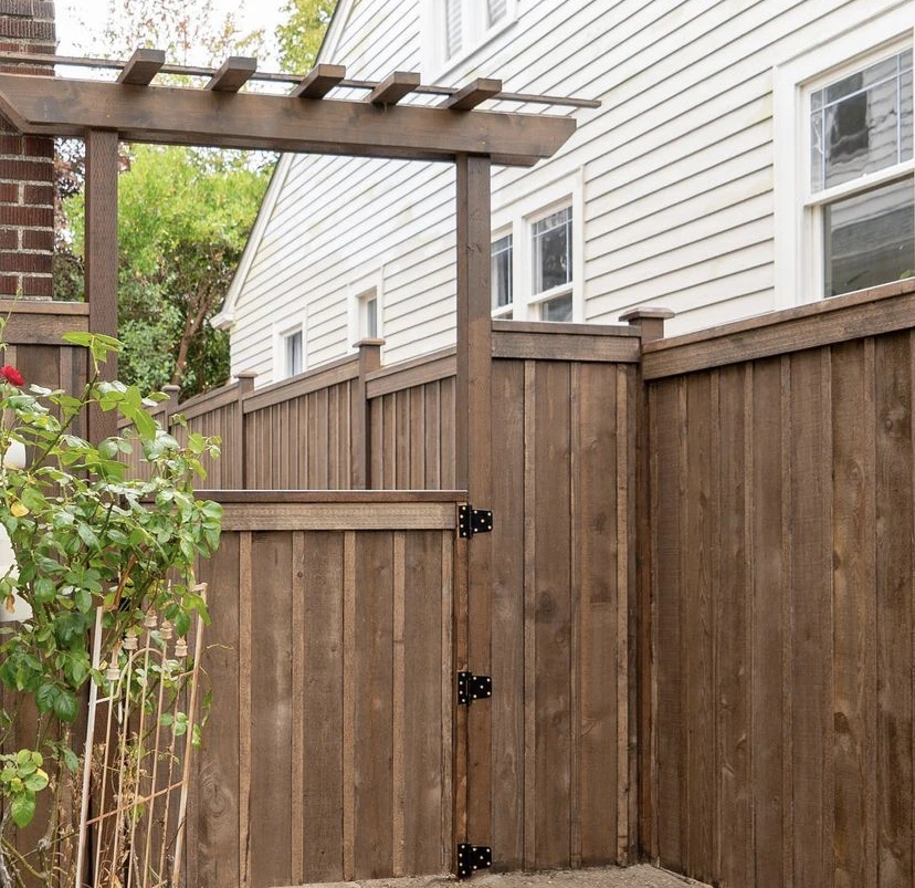 Dark stained cedar fence in Seattle after weather-proofing